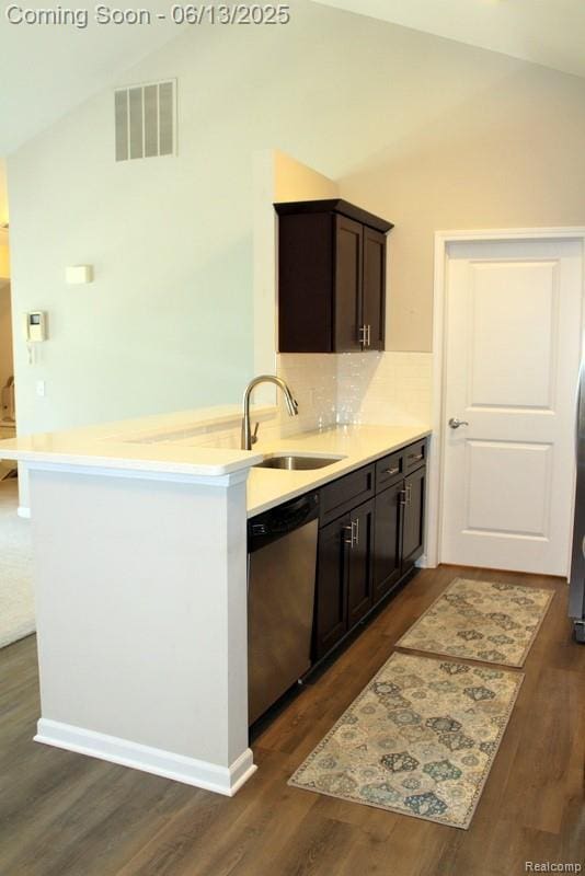 23413 Williamsburg Cir Unit 12, Woodhaven, MI 48183 - kitchen featuring dishwasher, lofted ceiling, dark wood finished floors, dark brown cabinets, and light countertops