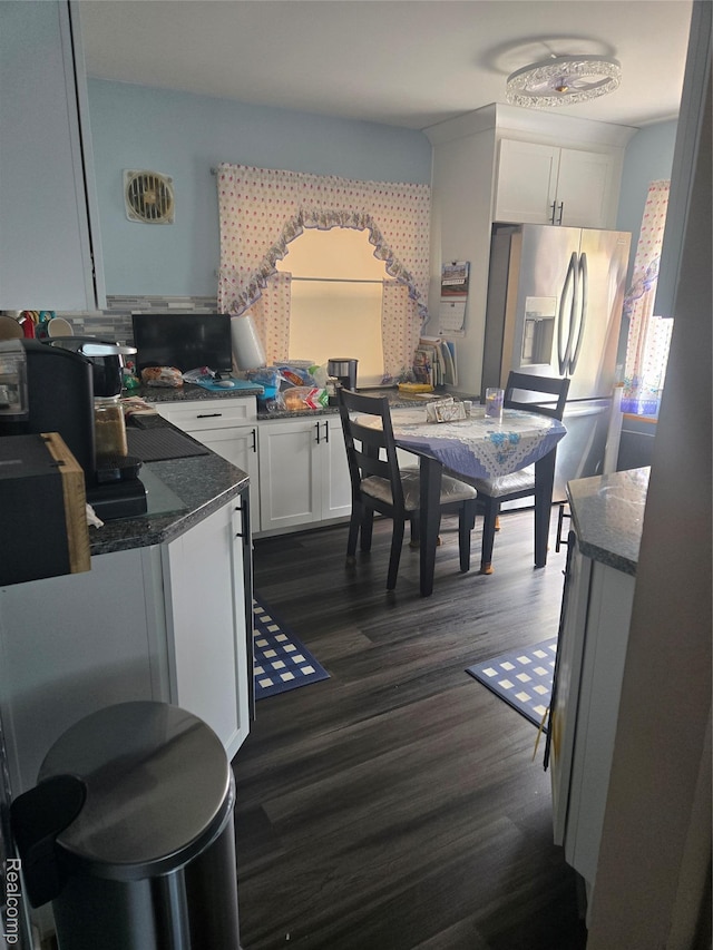 22612 Lyndon St, Detroit, MI 48223 - kitchen featuring stainless steel fridge, dark wood finished floors, white cabinetry, and dark stone countertops