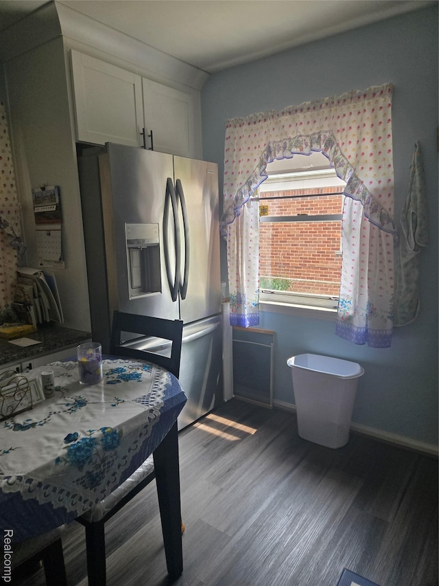 22612 Lyndon St, Detroit, MI 48223 - kitchen featuring stainless steel fridge with ice dispenser, wood finished floors, and white cabinets