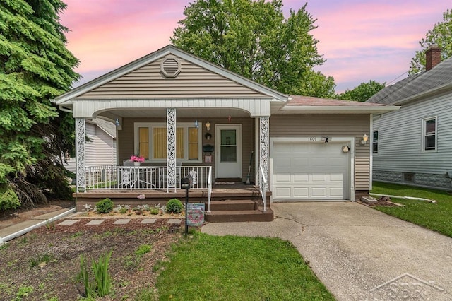 1601 S Monroe St, Bay City, MI 48708 - view of front of property with a porch, an attached garage, and driveway