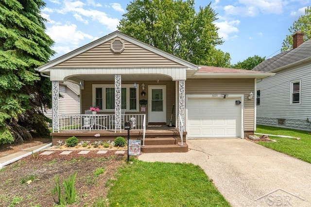 1601 S Monroe St, Bay City, MI 48708 - view of front of house featuring an attached garage, covered porch, driveway, and a front yard