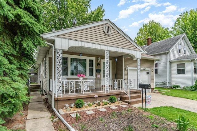 1601 S Monroe St, Bay City, MI 48708 - view of front of property featuring covered porch, an attached garage, and concrete driveway