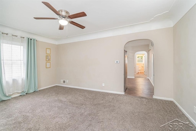 1601 S Monroe St, Bay City, MI 48708 - carpeted spare room featuring arched walkways, healthy amount of natural light, and ceiling fan