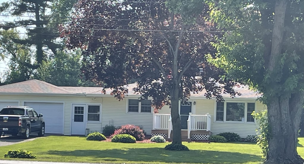 6384 Lansing Ave, Jackson, MI 49201 - view of front of house with a garage and a front lawn