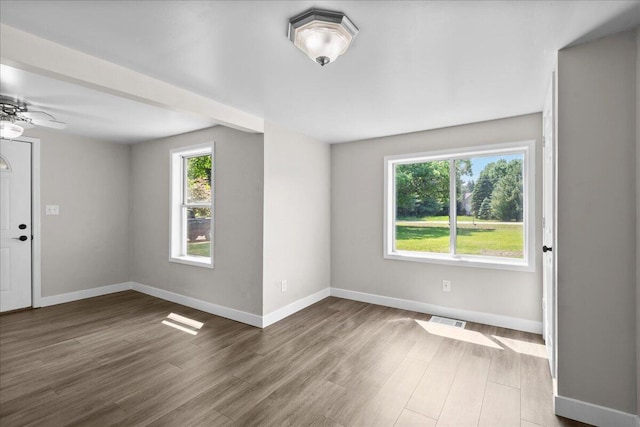 1178 Drent Rd, Muskegon, MI 49442 - empty room with wood finished floors and ceiling fan