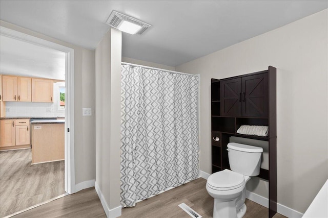 1178 Drent Rd, Muskegon, MI 49442 - full bathroom with wood finished floors, vanity, a shower with shower curtain, and backsplash