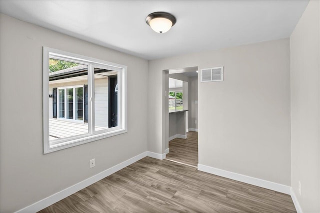 1178 Drent Rd, Muskegon, MI 49442 - empty room with plenty of natural light and wood finished floors