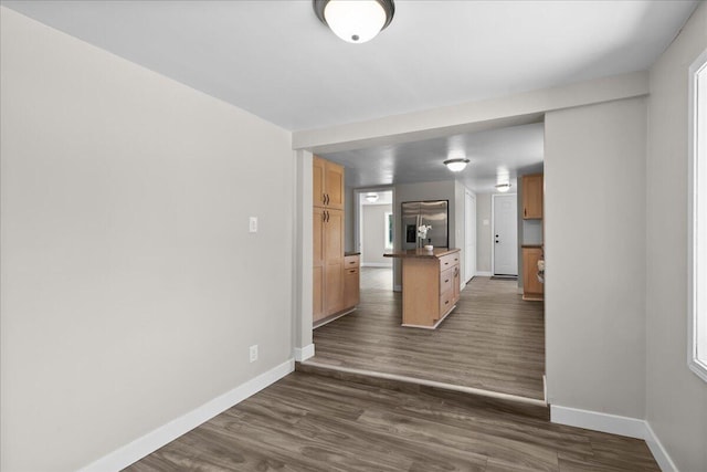 1178 Drent Rd, Muskegon, MI 49442 - kitchen featuring stainless steel refrigerator with ice dispenser, dark wood-style floors, dark countertops, and a center island