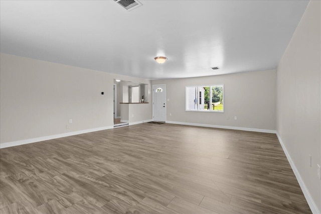1178 Drent Rd, Muskegon, MI 49442 - unfurnished living room featuring baseboards and wood finished floors