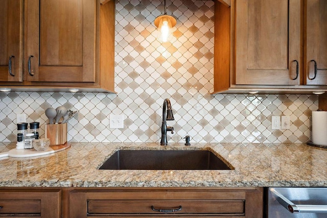 2753 Colton Dr, Berrien Springs, MI 49103 - kitchen with light stone counters, decorative backsplash, brown cabinetry, and stainless steel dishwasher