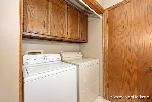 1861 Elizabeth Ln E, Jenison, MI 49428 - laundry room with cabinet space, separate washer and dryer, and light tile patterned floors