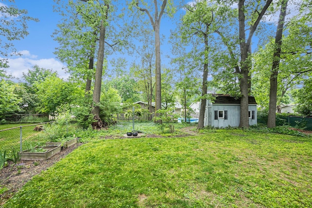 3923 Perry Ave SW, Wyoming, MI 49519 - fenced backyard with a garden and an outbuilding