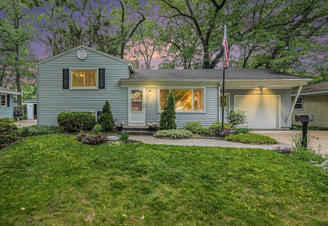 3923 Perry Ave SW, Wyoming, MI 49519 - tri-level home featuring a garage, concrete driveway, and a yard