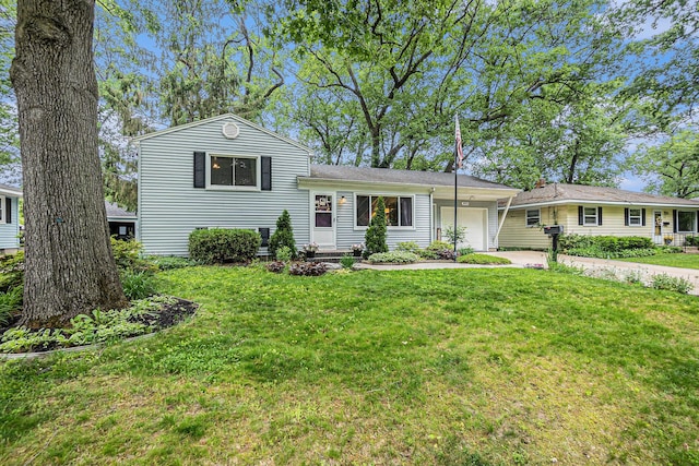 3923 Perry Ave SW, Wyoming, MI 49519 - tri-level home with an attached garage, a front lawn, and driveway