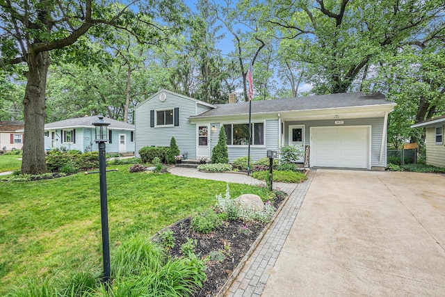3923 Perry Ave SW, Wyoming, MI 49519 - tri-level home featuring a garage, concrete driveway, a front yard, and a chimney