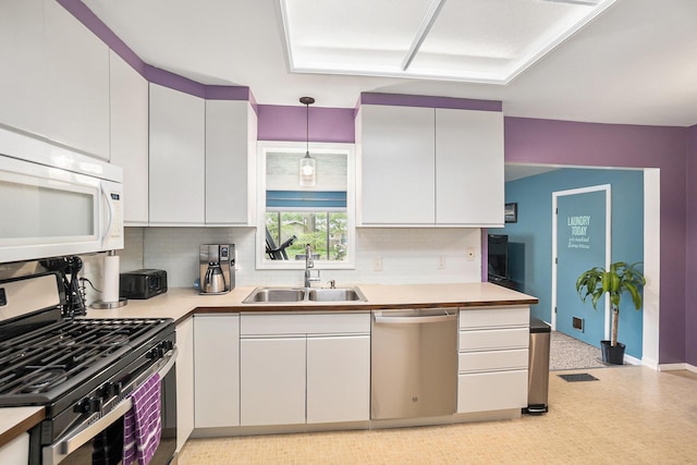 3923 Perry Ave SW, Wyoming, MI 49519 - kitchen featuring stainless steel appliances, white cabinetry, and decorative backsplash