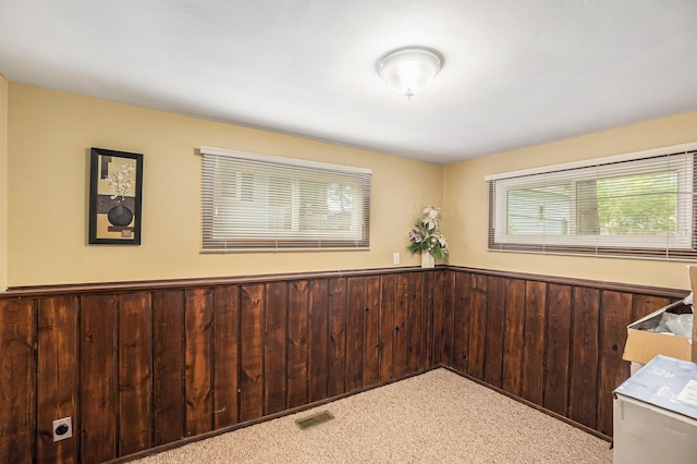 3923 Perry Ave SW, Wyoming, MI 49519 - empty room featuring carpet floors, wainscoting, and wood walls