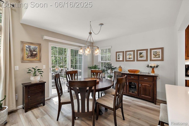 372 Four Seasons Dr, Lake Orion, MI 48360 - dining space with light wood-type flooring and a chandelier