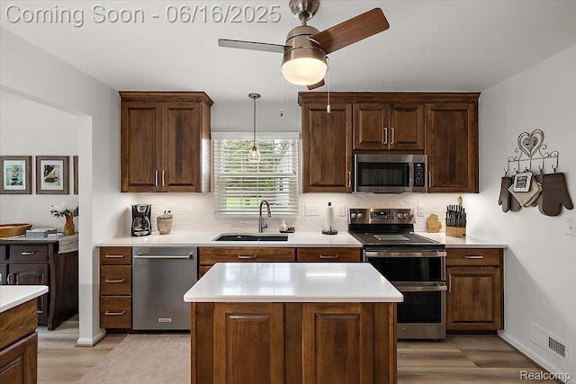 372 Four Seasons Dr, Lake Orion, MI 48360 - kitchen with stainless steel appliances, light wood finished floors, and decorative backsplash