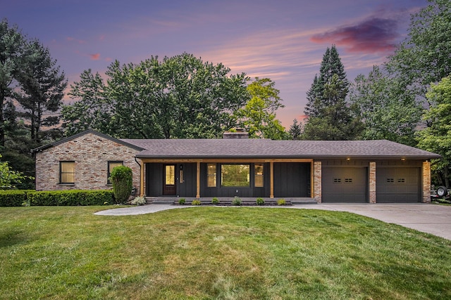 3737 Peach Ridge Ave NW, Grand Rapids, MI 49544 - view of front of home with an attached garage, a front yard, concrete driveway, brick siding, and a chimney