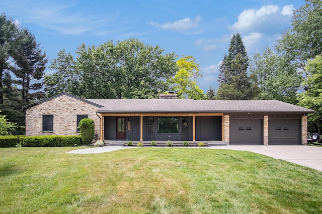 3737 Peach Ridge Ave NW, Grand Rapids, MI 49544 - view of front of home with a garage, concrete driveway, a front yard, and brick siding