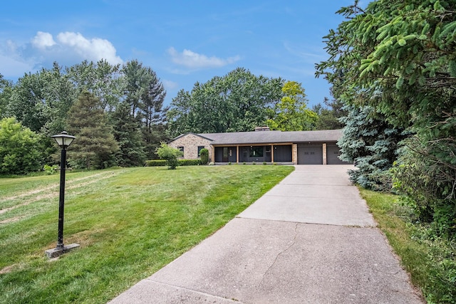 3737 Peach Ridge Ave NW, Grand Rapids, MI 49544 - view of front of property featuring an attached garage, a front lawn, driveway, and a chimney