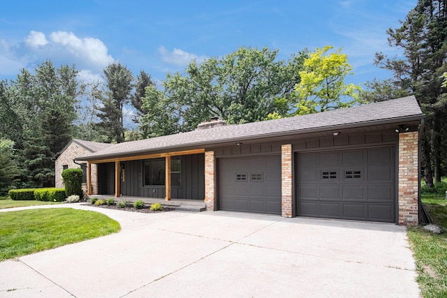 3737 Peach Ridge Ave NW, Grand Rapids, MI 49544 - view of front of property with board and batten siding, driveway, an attached garage, and covered porch