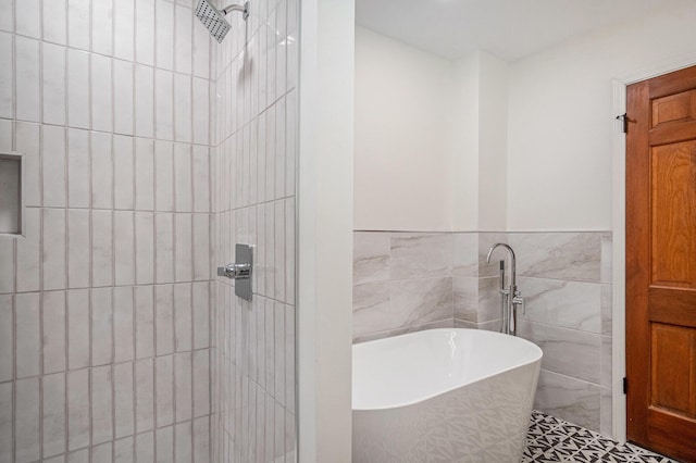 3737 Peach Ridge Ave NW, Grand Rapids, MI 49544 - full bathroom with tiled shower, tile walls, a freestanding bath, and a wainscoted wall