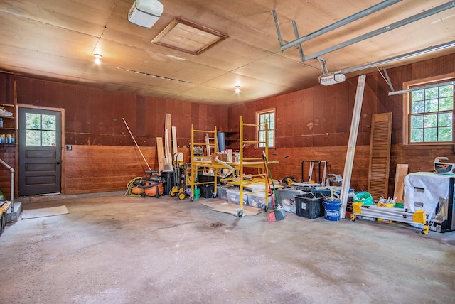 3737 Peach Ridge Ave NW, Grand Rapids, MI 49544 - garage featuring wooden walls and a garage door opener