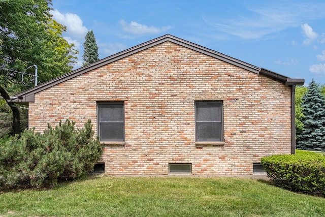 3737 Peach Ridge Ave NW, Grand Rapids, MI 49544 - view of side of home with a yard and brick siding