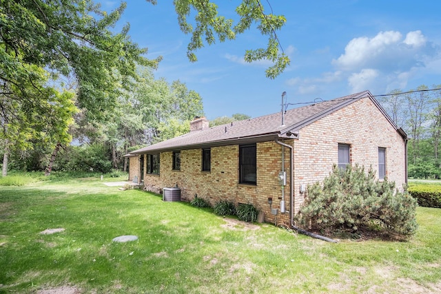 3737 Peach Ridge Ave NW, Grand Rapids, MI 49544 - view of property exterior with brick siding, a chimney, a lawn, and a shingled roof