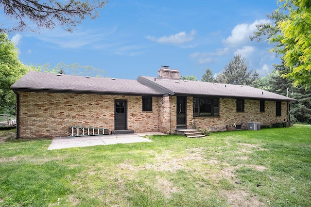 3737 Peach Ridge Ave NW, Grand Rapids, MI 49544 - back of property featuring a patio area, brick siding, a lawn, a chimney, and a shingled roof