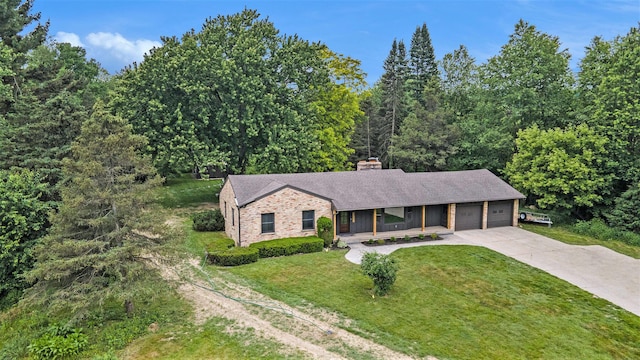 3737 Peach Ridge Ave NW, Grand Rapids, MI 49544 - single story home with covered porch, a garage, concrete driveway, a front lawn, and a chimney