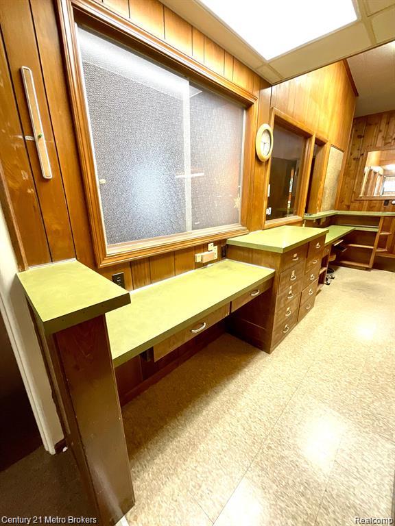 106 N Marquette St, Durand, MI 48429 - bathroom with wood walls and tile patterned floors