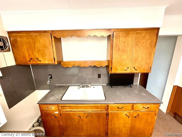 106 N Marquette St, Durand, MI 48429 - kitchen with decorative backsplash and brown cabinetry