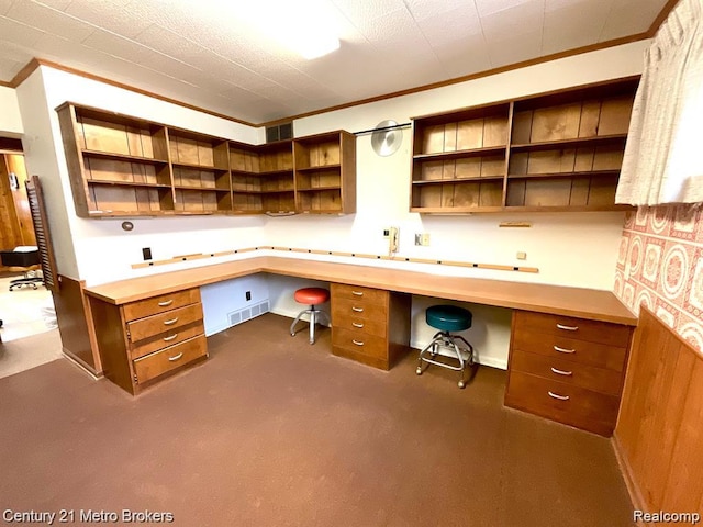 106 N Marquette St, Durand, MI 48429 - unfurnished office with built in desk, crown molding, and dark colored carpet