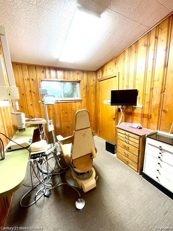 106 N Marquette St, Durand, MI 48429 - carpeted office space with wooden walls