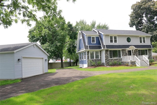 19904 Mckinnon St, Roseville, MI 48066 - view of front of home with asphalt driveway, a garage, stone siding, and an outbuilding