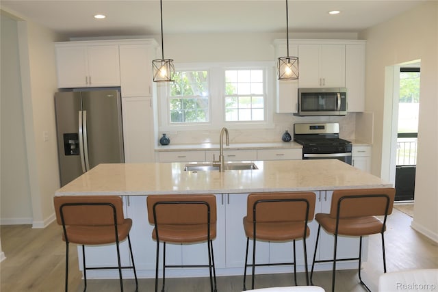 19904 Mckinnon St, Roseville, MI 48066 - kitchen featuring stainless steel appliances, light wood-style floors, tasteful backsplash, white cabinets, and recessed lighting
