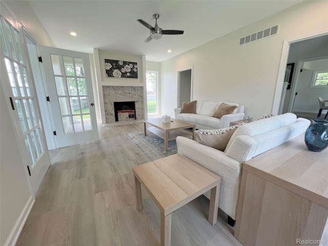 19904 Mckinnon St, Roseville, MI 48066 - living area featuring light wood-style floors, a ceiling fan, healthy amount of natural light, a large fireplace, and recessed lighting