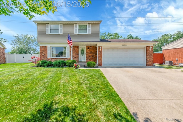 22086 Hillcrest Ct, Woodhaven, MI 48183 - view of front of house with brick siding, an attached garage, and driveway