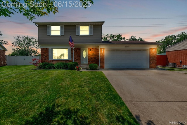 22086 Hillcrest Ct, Woodhaven, MI 48183 - traditional-style home with brick siding, a garage, and concrete driveway