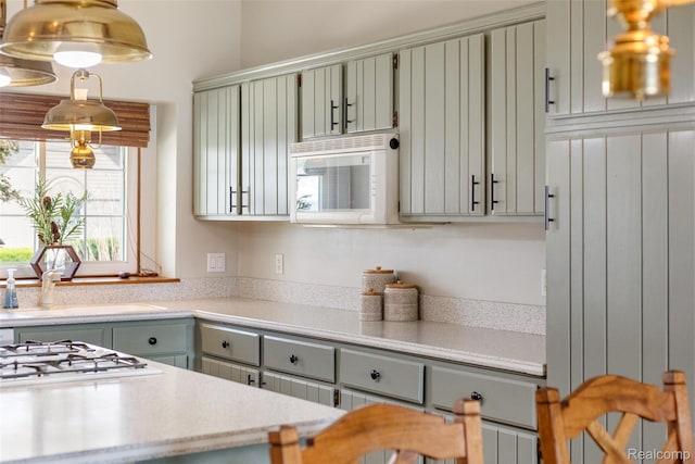 35772 Bal Clair St, New Baltimore, MI 48047 - kitchen with light countertops, white appliances, and decorative light fixtures