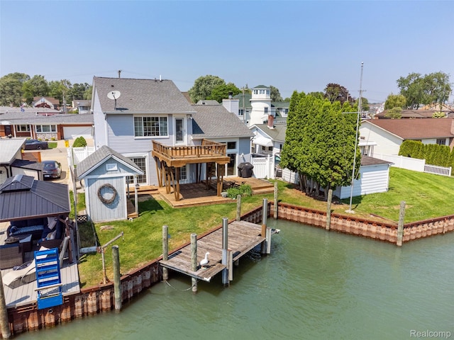 35772 Bal Clair St, New Baltimore, MI 48047 - rear view of property with a deck with water view, a shed, a fenced backyard, a residential view, and a shingled roof