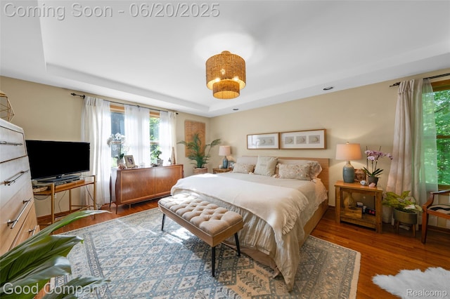 115 Audubon Dr, White Lake, MI 48383 - bedroom featuring a raised ceiling and wood finished floors