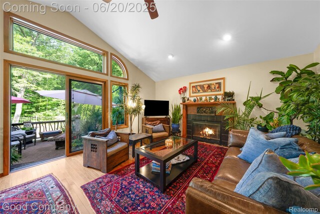 115 Audubon Dr, White Lake, MI 48383 - living area with light wood finished floors, a tile fireplace, high vaulted ceiling, ceiling fan, and recessed lighting