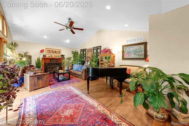 115 Audubon Dr, White Lake, MI 48383 - living area with ceiling fan, wood finished floors, vaulted ceiling, a fireplace, and recessed lighting