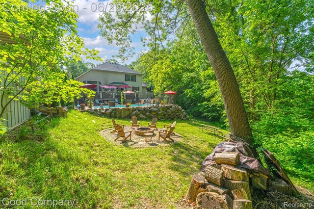 115 Audubon Dr, White Lake, MI 48383 - view of yard with a fire pit and an outdoor pool
