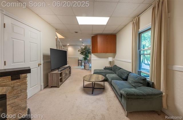 115 Audubon Dr, White Lake, MI 48383 - living area with light carpet, a paneled ceiling, and a wainscoted wall