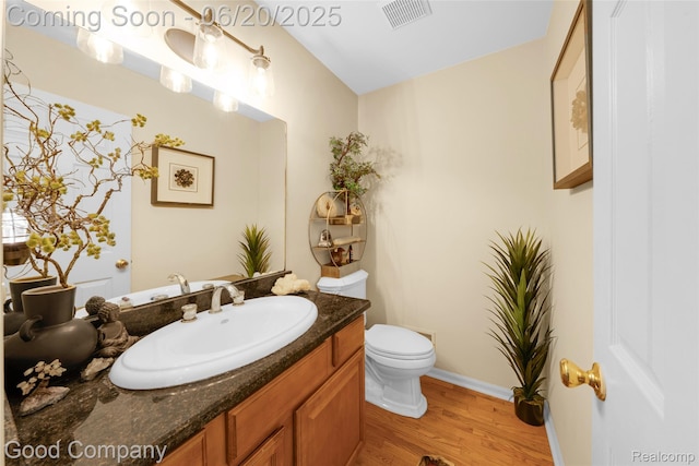 115 Audubon Dr, White Lake, MI 48383 - half bath featuring vanity and wood finished floors